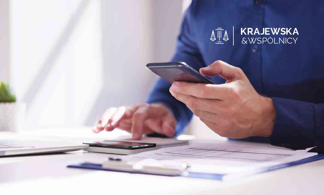 Ekspert kancelarii weryfikuje koszty windykacji sądowej na smartfonie podczas analizy akt sprawy.